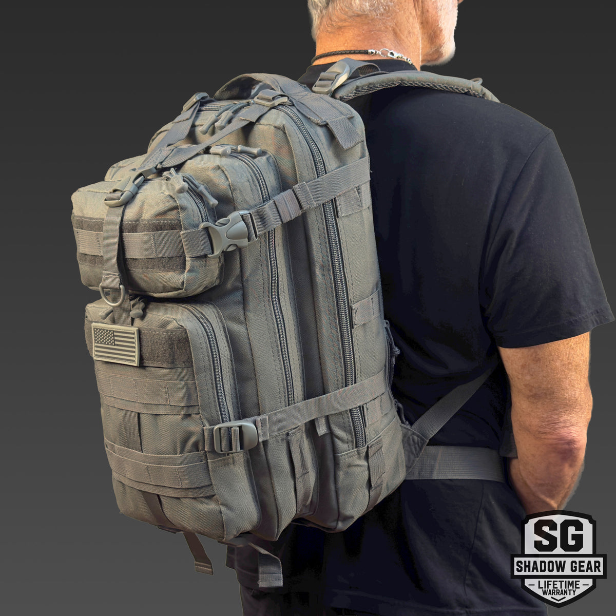 Man wearing the Shadow Gear Summit 28L tactical daypack in Charcoal, studio shot