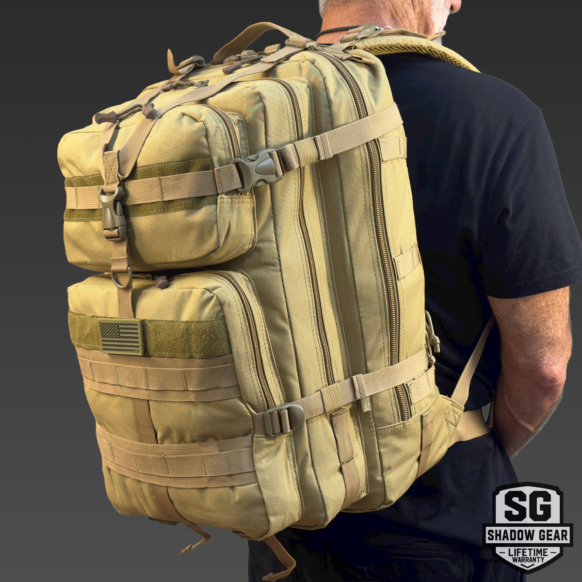 Man wearing the Shadow Gear Summit XL 52L large tactical rucksack in Tan, studio lifestyle shot