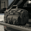 Tactical duffel bag on a truck bed with an American flag patch